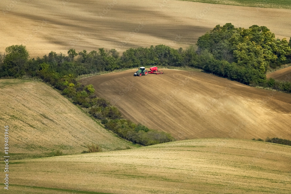Tractor, photographed in the agricultural field during the processing of Pesticides. Moravia, Czech Republic