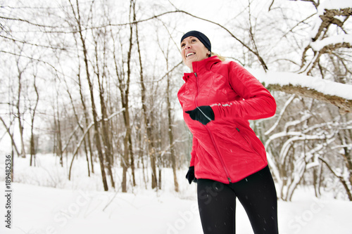 Blond woman running outdoors on a cold winter day