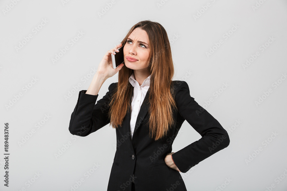 Thoughtful brunette lady talking on smartphone Thoughtful brunette lady talking on smartphone