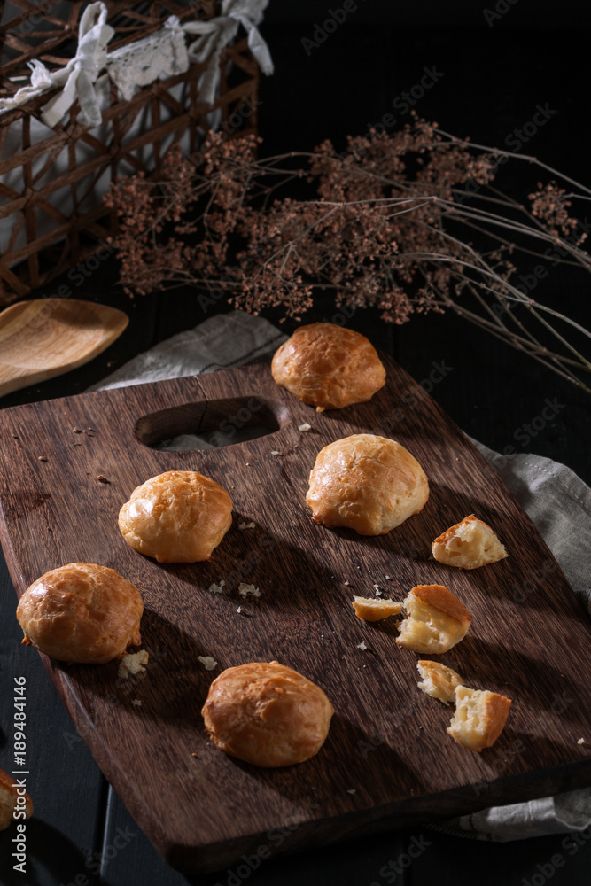 Small snack cheese bread with black wooden
