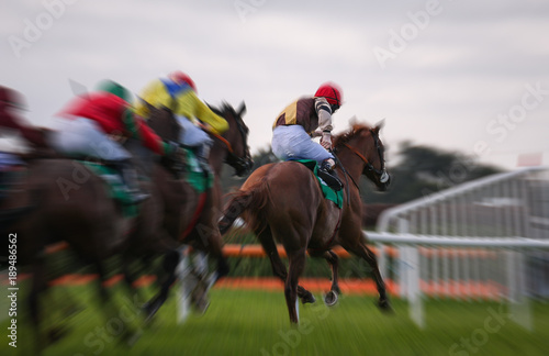 Motion blur of Galloping racehorses racing down the track