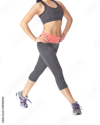 Low section of sportive woman going on a white background
