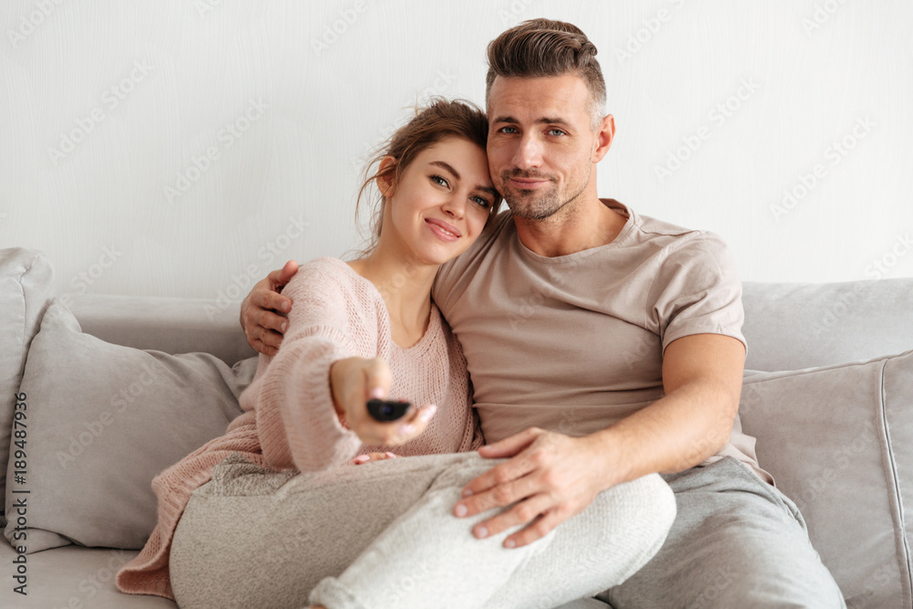 Portrait of an attractive young couple sitting on a couch Portrait of an attractive young couple sitting on a couch
