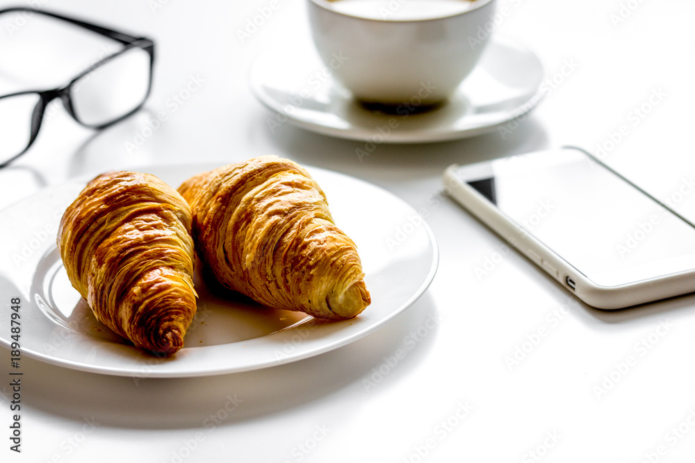 Breakfast for businessman with coffee and croissant on white tab