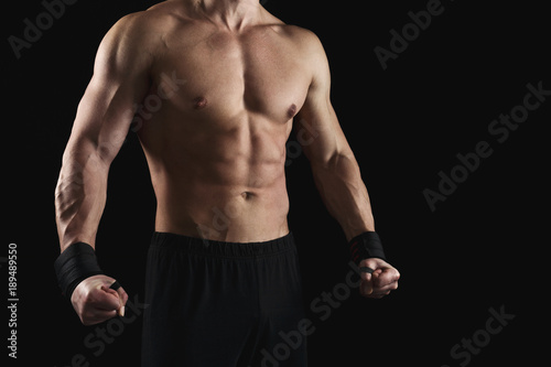 Strong athletic man showes naked muscular body
