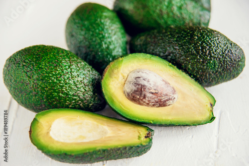 Group of organic fresh ripe and unripe avocados isolated on white background