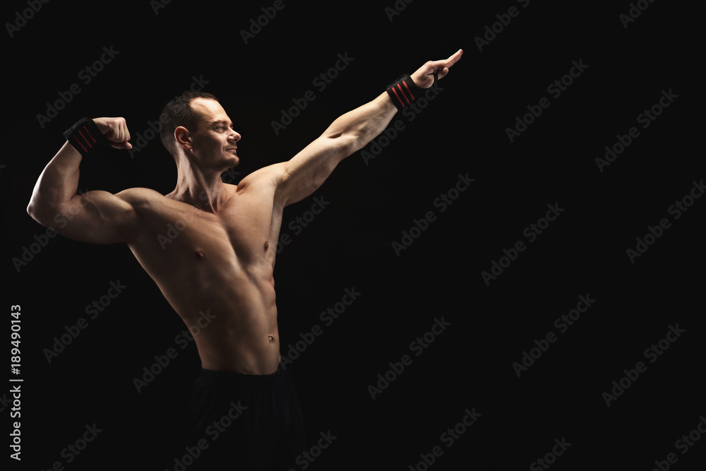 Strong athletic man showes naked muscular body Strong athletic man showes naked muscular body