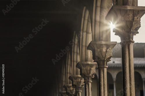 Ancient cloister arch,shadow and sun star. photo