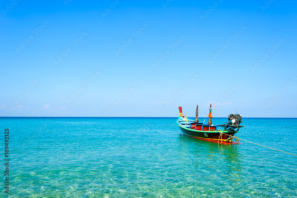 Long-tail boats converted boat excursions In order to serve tourists cruising the island of Andaman Sea coast beaches on a sunny day and the good weather in travel and  transportation concept.
