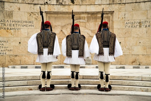 Greek Presidential Guard (evzone) in national clothes uniform at the tomb of unknown soldier in Athens, Greece. Ceremonial ritual changing guards.