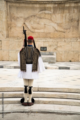 Greek Presidential Guard (evzone) in national clothes uniform at the tomb of unknown soldier in Athens, Greece. Ceremonial ritual changing guards.