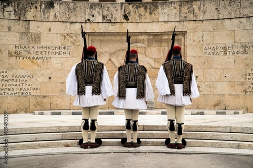 Greek Presidential Guard (evzone) in national clothes uniform at the tomb of unknown soldier in Athens, Greece. Ceremonial ritual changing guards. photo