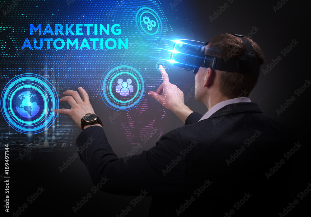 Business, Technology, Internet and network concept. Young businessman working on a virtual screen of the future and sees the inscription: Marketing automation Business, Technology, Internet and network concept. Young businessman working on a virtual screen of the future and sees the inscription: Marketing automation