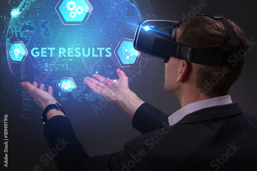 Business, Technology, Internet and network concept. Young businessman working on a virtual screen of the future and sees the inscription: Get results