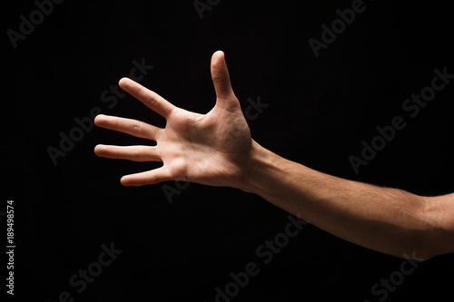Taking hand isolated on black background