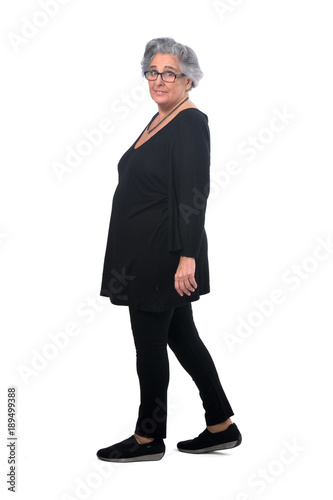 portrait of a senir woman walking on white photo