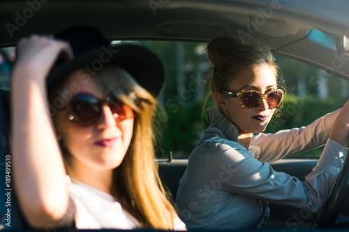 Two girl friends on a road trip by car © creativefamily