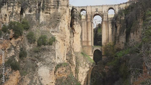 tourists stand on a rock and look at a magnificent mountain landscape and architecture