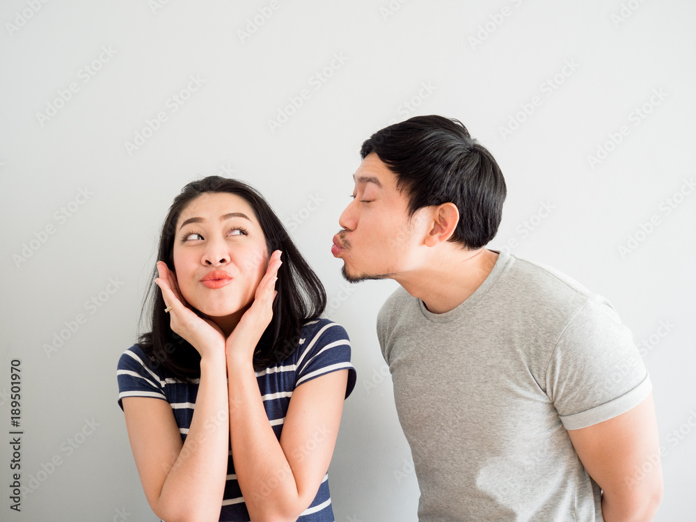 Funny lovely couple trying to kiss each other. Concept of comedy love.  Stock Photo | Adobe Stock