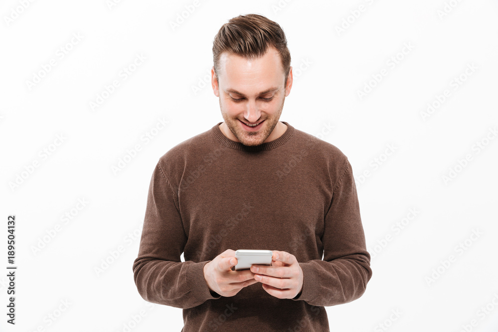 Handsome young man chatting by mobile phone Handsome young man chatting by mobile phone