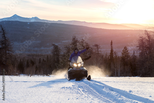 Athletes on a snowmobile.