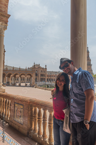 handsome happy couple take photo in Spain Square (Plaza de Espana), Seville, Spain, during a world trip tour