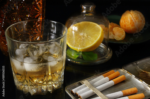 Whiskey, cigarettes and fruits photo