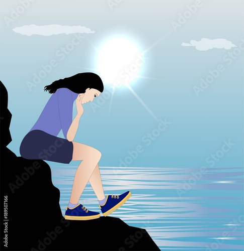 Sad girl sitting on a cliff facing the sea