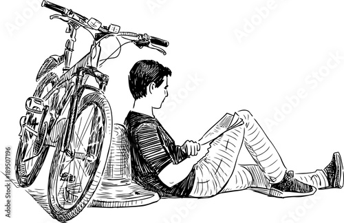 A cyclist resting on the city embankment