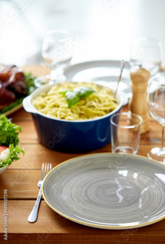 empty plate and fork on wooden table with food