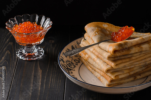 Traditional Russian pancakes with red caviar photo