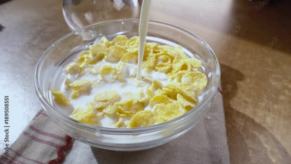 Crispy yellow corn flakes into the bowl for the morning a delicious Breakfast with milk. Slow motion with rotation tracking shot. Crispy yellow corn flakes into the bowl for the morning a delicious Breakfast with milk. Slow motion with rotation tracking shot.
