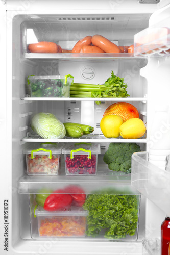 Wallpaper Mural Open refrigerator full of different products Torontodigital.ca