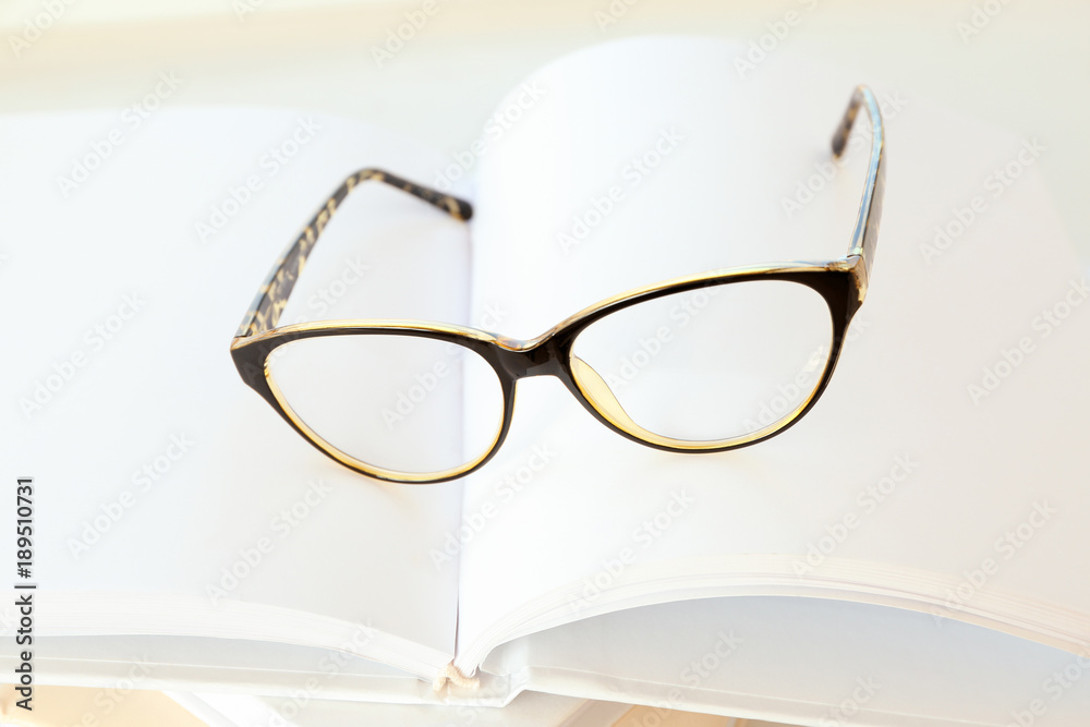 Glasses on notebook, closeup. Preparation for exam