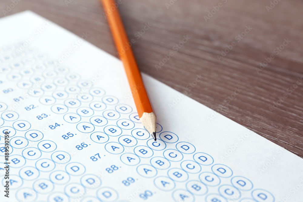 Pencil and test sheet on table, closeup. Preparation for exam Pencil and test sheet on table, closeup. Preparation for exam
