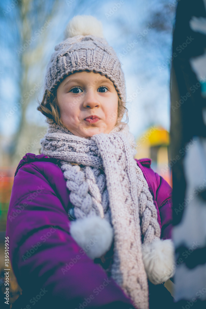 A cute little girl on a playground in autumn. A cute little girl on a playground in autumn.