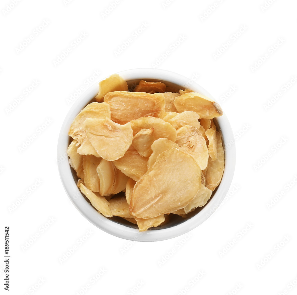 Dried garlic flakes in bowl on white background Dried garlic flakes in bowl on white background