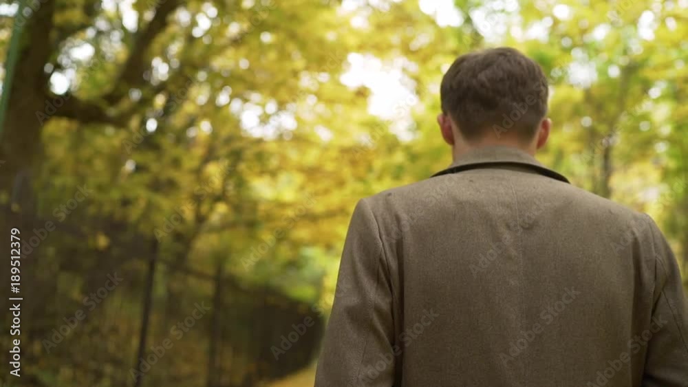 the guy in the coat walks through the autumn forest the guy in the coat walks through the autumn forest