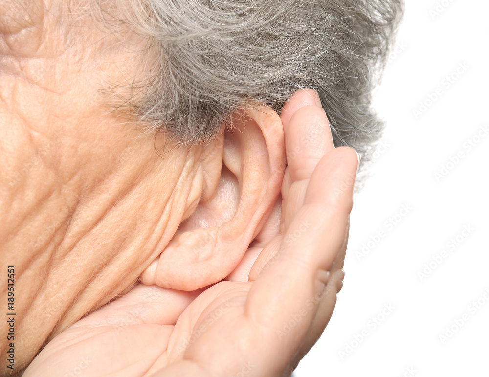 Elderly woman with hearing problem on white background, closeup Elderly woman with hearing problem on white background, closeup