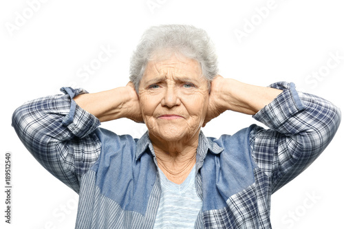 Elderly woman covering her ears on white background. Hearing problem