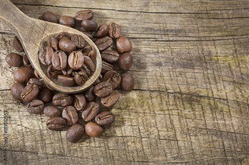 Roasted coffee on the wooden background - Coffea