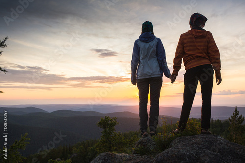 Couple Watching Sunset Mountain Outdoors Concept