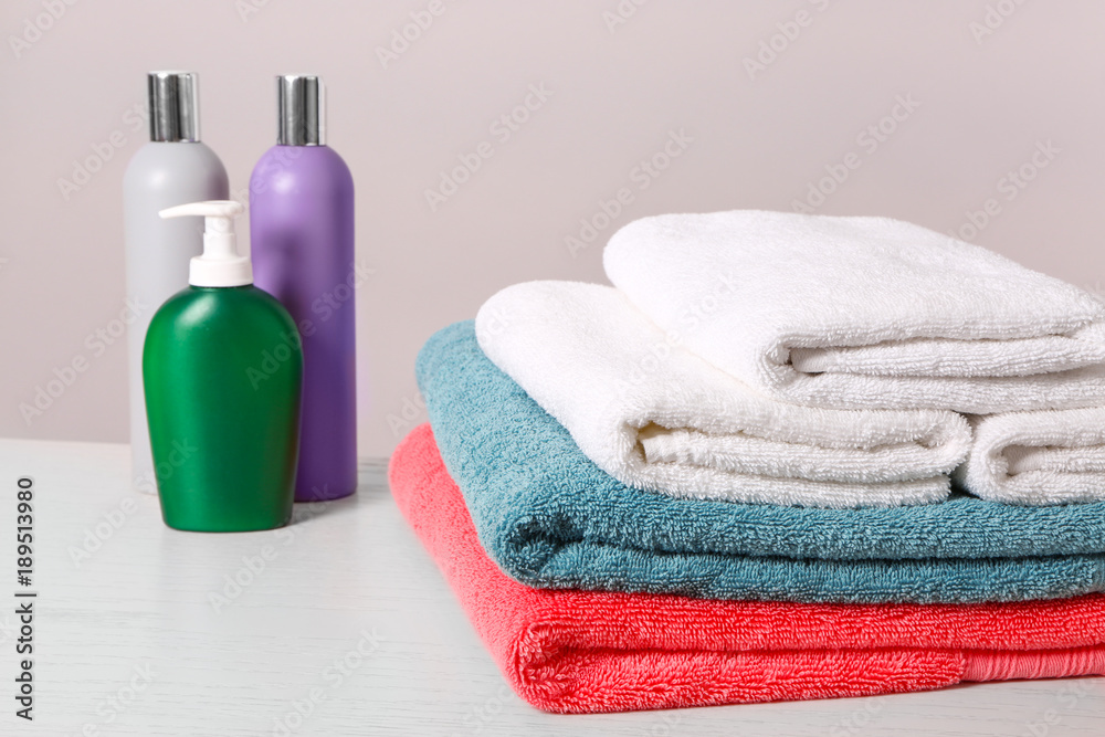 Clean towels and toiletries on table Clean towels and toiletries on table