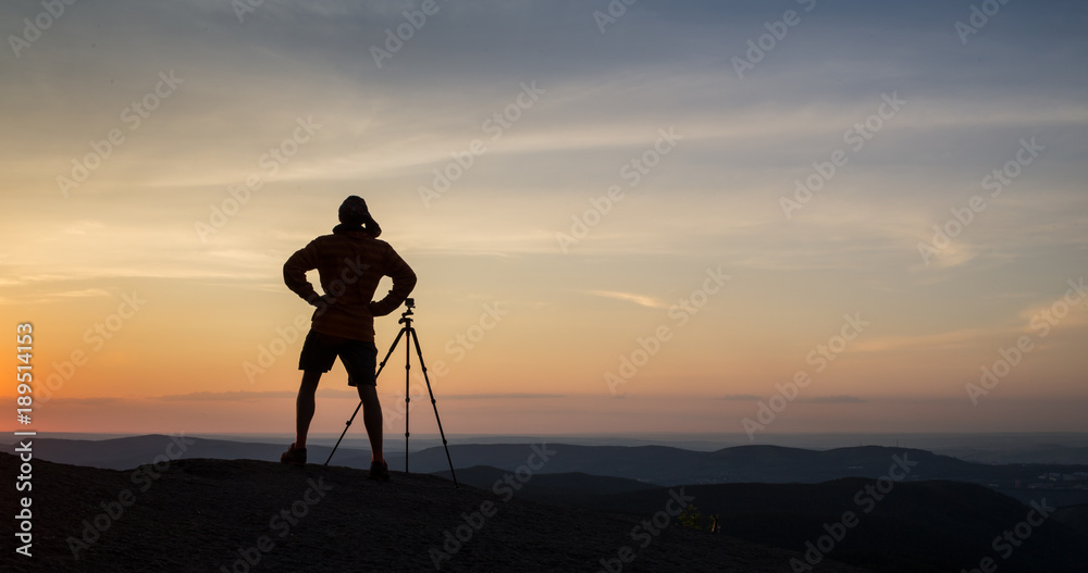 Silhouette of photographer taking photo in sunset