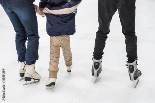 Family ice skating at rink. Winter activities