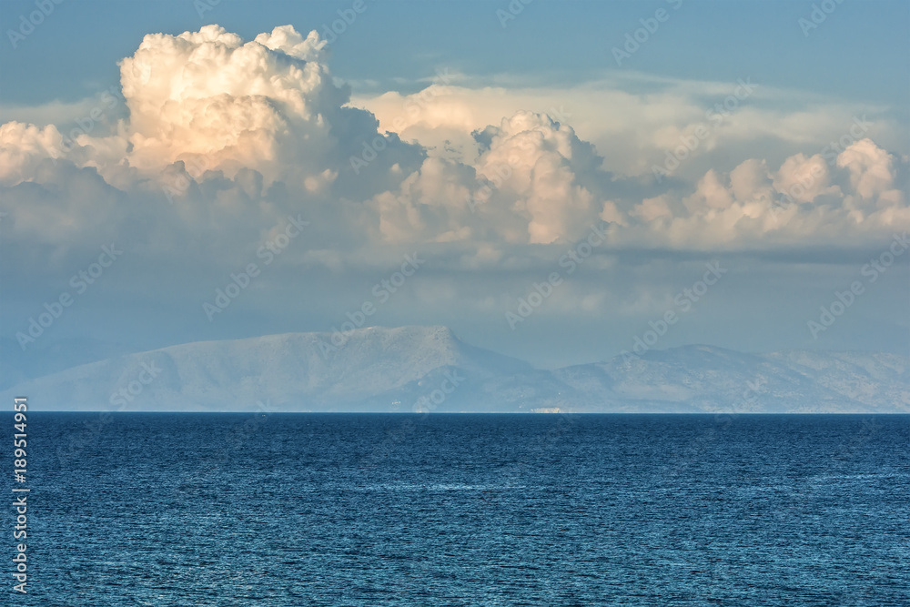 Scenic view on sea, mountain and clouds.