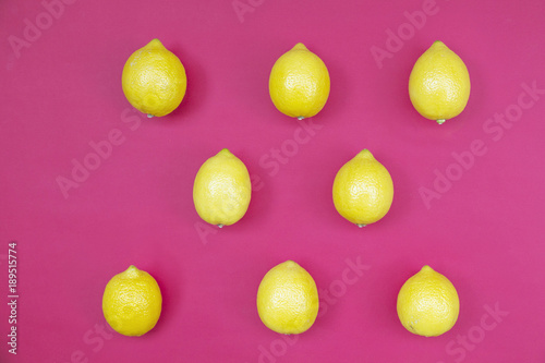 Top view of colorful fruit pattern of fresh lemon on pink background