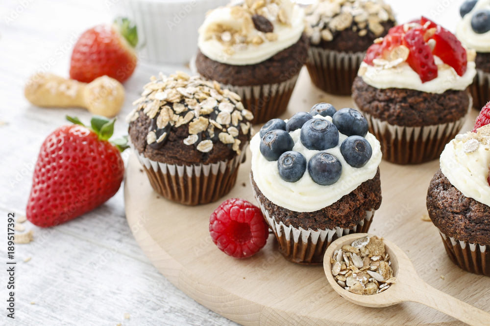 Muffins decorated with fresh fruits and oatmeal flakes