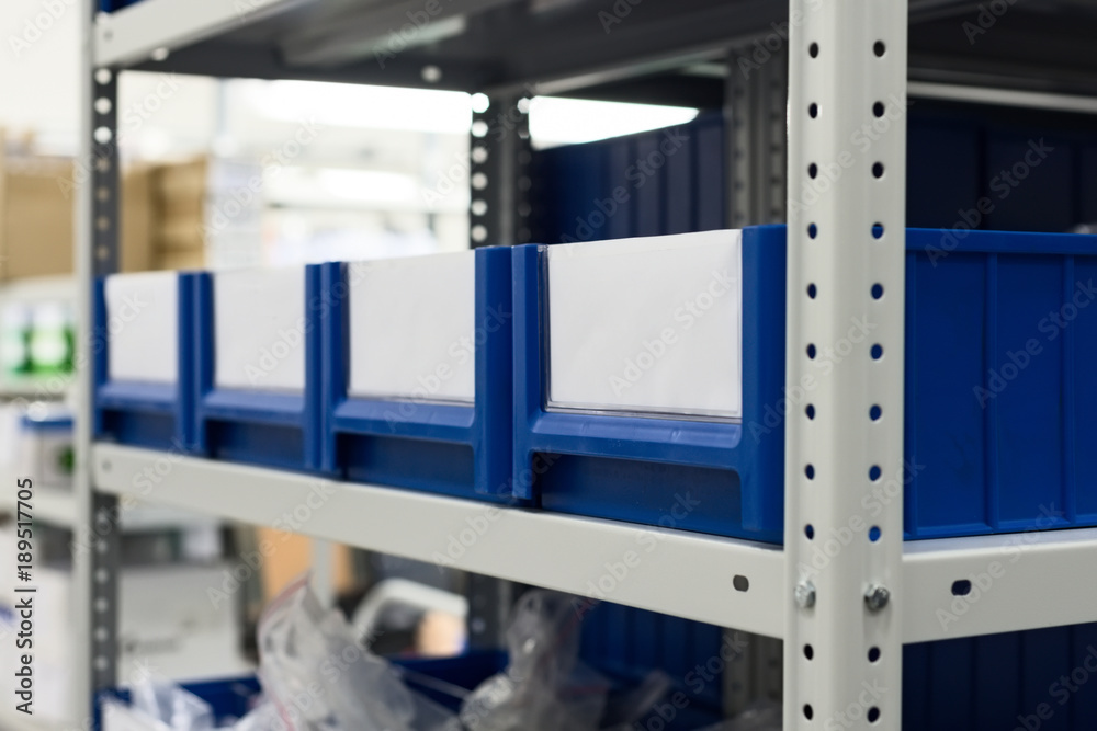 Blue plastic boxes placed in shelves. Blue plastic boxes placed in shelves.