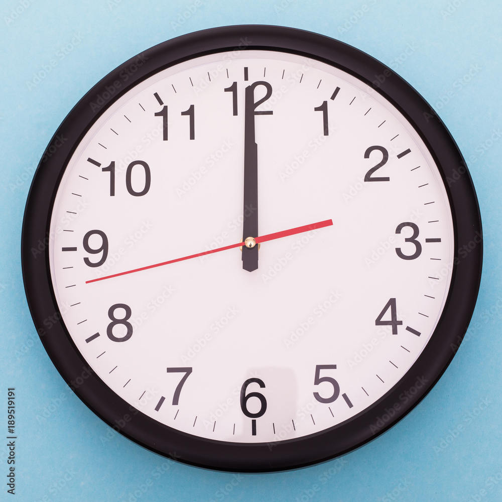 Wall clock isolated on blue background. Twelve o'clock Wall clock isolated on blue background. Twelve o'clock
